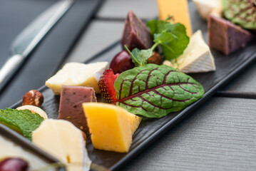 Fruit, meat and cheese assortment on the table. Exquisite food