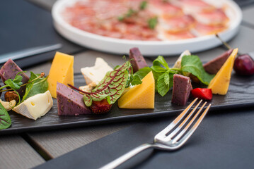 Fruit, meat and cheese assortment on the table. Exquisite food