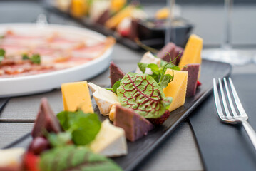 Fruit, meat and cheese assortment on the table. Exquisite food