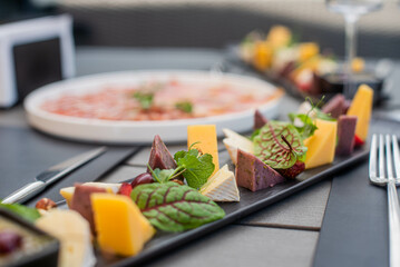 Fruit, meat and cheese assortment on the table. Exquisite food