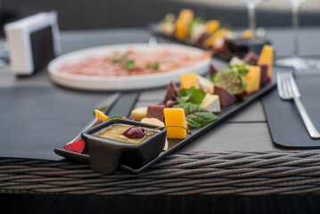 Fruit, meat and cheese assortment on the table. Exquisite food