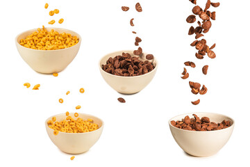 Chocolate corn flakes falling to the white bowl isolated on white. Motion.