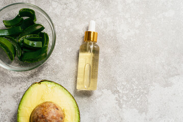 Aloe and avocado oil on a gray background. Natural extract oil.