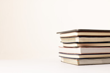 Image of stack of books on beige surface