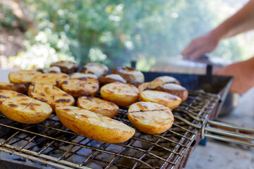 Close-up of delicious grilled potatoes on barbecue grill 