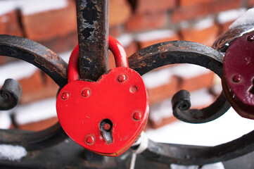 locks in the form of hearts on the iron fence in winter. Symbol of love and fidelity