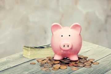 A piggy bank with banknotes and coins. Concepts of Finance, saving money and economy.