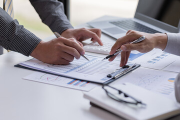 Close up of Team businesswoman Accounting using calculating income-expenditure and analyzing real estate investment data report Financial and tax systems concept.