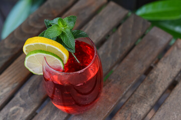 Closeup view of tasty cocktail on wooden table, space for text. Refreshing drink
