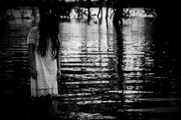 Portrait of asian woman make up ghost face at the swamp,Horror in water scene,Scary at...
