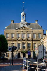 Weesp, Netherlands - July 05. 2022.  Town hall (Stadhuis) against a clear blue sky.