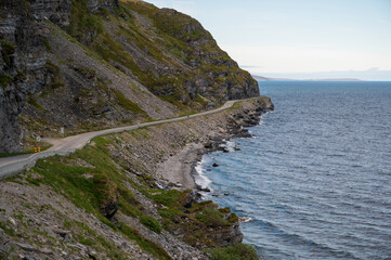 Road under a rocky cliff on the coast