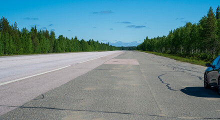 Wide asphalt road in the forest