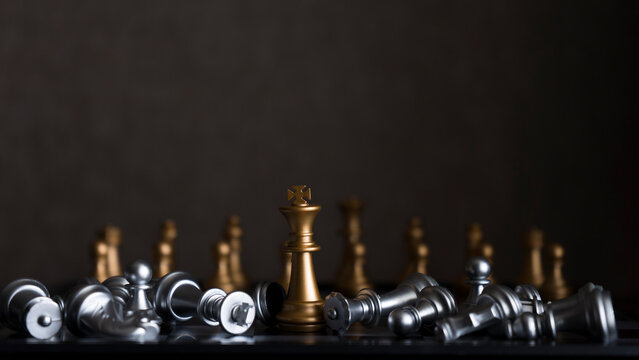 Chess pieces on a chessboard on a dark background