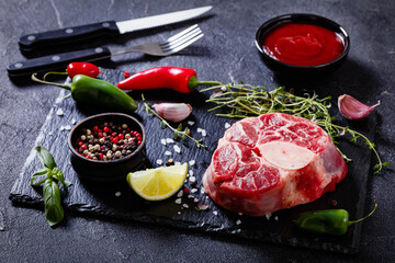 raw osso buco, veal shank steak on stone board