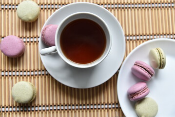 Tea pair with fragrant tea and pasta on a wooden mat.