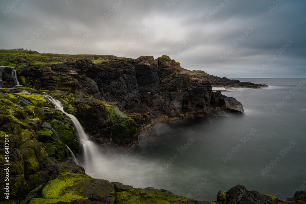 Wall mural long exposure view of the picturesque Irish coast and Dunseverick waterfall in summer