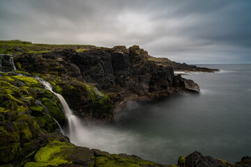 long exposure view of the picturesque Irish coast and Dunseverick waterfall in summer