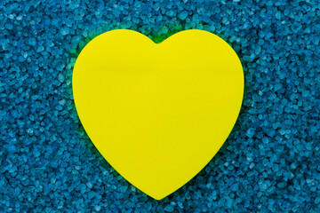 Paper sticker in the shape of a heart on the background of sea aromatic bath salts. The concept of...