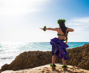 Hula dancer on the beach. Woman in bikini dancing Hawaiian typical of Tahiti. Tropical lady at...