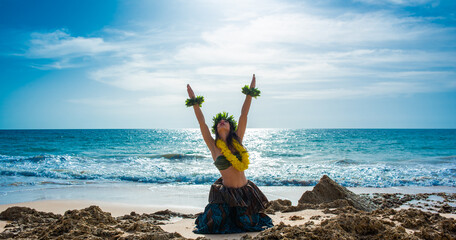 Hula dancer on the beach. Woman in bikini dancing Hawaiian typical of Tahiti. Tropical lady at beach with flower crown on her head and neck. Ready to party. Exotic girl in swimwear.