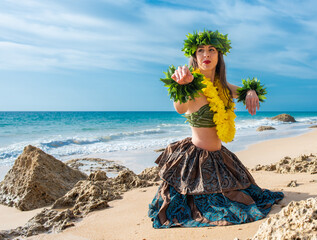 Hula dancer on the beach. Woman in bikini dancing Hawaiian typical of Tahiti. Tropical lady at beach with flower crown on her head and neck. Ready to party. Exotic girl in swimwear.