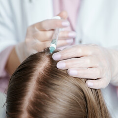 Trichologist makes an injection in the scalp, head skin for hair treatment. Beautician and the...