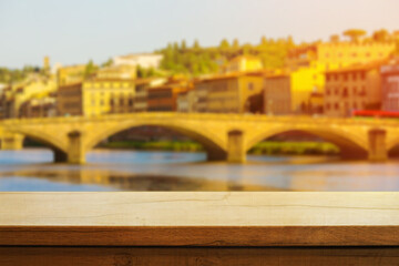 beautiful wooden table on the background of italian florence during sunset. Copy space. Product demo template concept
