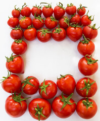 Photo of a ripe tomato on a white background in the form of a frame with a place for text.  product packaging design of tomato juice, pasta, croutons, chips.  Banner, signboard and background 