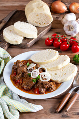 Czech traditional recipe for goulash with homemade dumpligs, served in simple rustic style