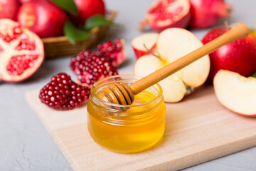 Rosh hashanah, jewish holiday, concept: honey, apple and pomegranate with cutting board, close up
