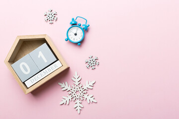 Christmas wood calendar with new year decorations, aganist colored background. Christmas calendar 1...