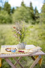 Wildflowers in vase on the table at picnic outdoors