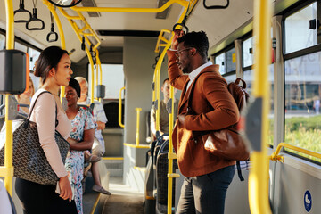 Asian woman and black man riding bus