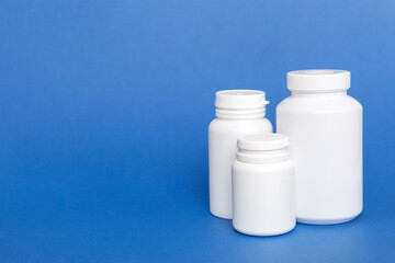 supplement pills with medicine bottle health care and medical top view. Vitamin tablets. Top view mockup bottle for pills and vitamins with green leaves, natural organic bio supplement, copy space