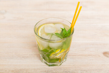 Mojito cocktail. Refreshing mojito cocktail with lime, lemon and mint in a tall glass with a stick