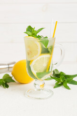 Mojito cocktail. Refreshing mojito cocktail with lime, lemon and mint in a tall glass with a stick