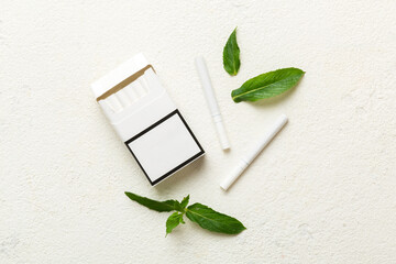 Pack of menthol cigarettes and fresh mint on colored table, Menthol cigarettes top view flat lay