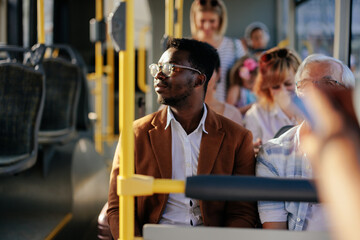 Young black man riding city public bus