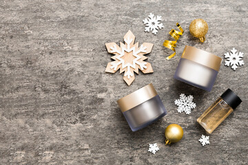 Makeup products and Christmas decorations on color background. Top view New year Beauty concept