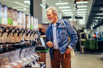 Man is looking for groceries in market.