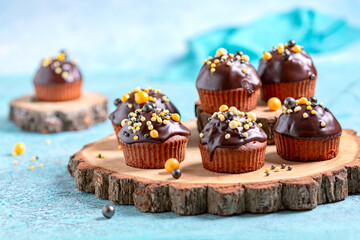 Chocolate sponge cakes or muffins with chocolate icing.