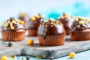 Chocolate muffins with chocolate icing close up.