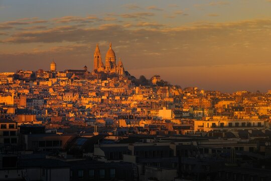 Scenic view of the Basilica of the Sacred Heart of Paris on top of a hill at golden hour in France - Powered by Adobe