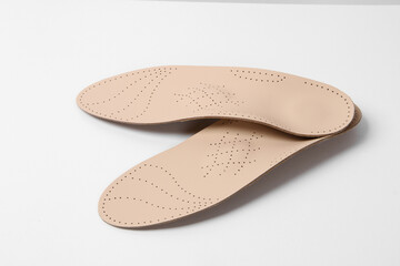 Insoles isolated on a white background. Medical orthopedic insoles. Foot care. Insole cutaway layers. Treatment and prevention of flat feet and foot diseases. Inner soles of shoes
