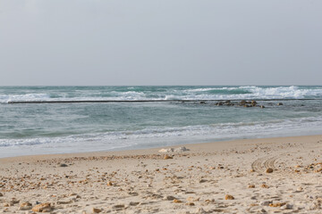 Sky, sea and sand with pebbles as a background. Natural landscape view of a beautiful tropical beach and sea on a sunny day. Beach sea area. Panorama of a beautiful beach with turquoise water banner