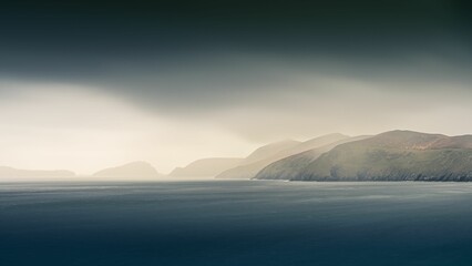 Breathtaking view of the Dingle Peninsula from the Atlantic Ocean on dark cloudy sky background