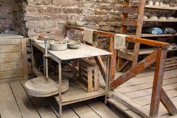Potter's workshop. A working table with clay and a potter's wheel.