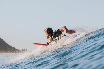 Stunning view of a surfer catches a wave in Mount Maunganui, New Zealand