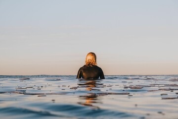 Rear view of a surfer in Mount Maunganui, New Zealand